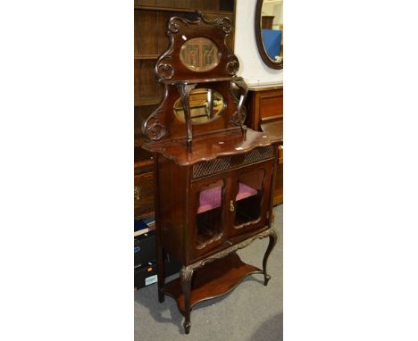 Late Victorian mahogany and stained wood side cabinet, shaped back with scrolled outlines and two oval bevelled plates, base 