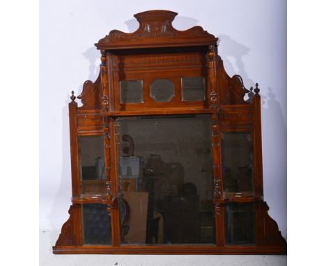Late Victorian stained walnut overmantel, with eight mirror plates, part canopied, width 115cm.