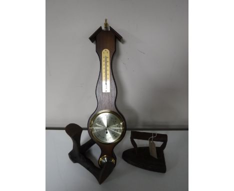 A contemporary barometer together with a cobbler's last and a flat iron