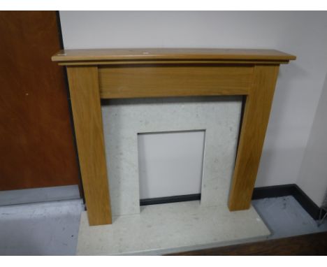 A contemporary oak fire surround, marble hearth and back 