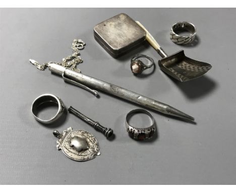 A small collection of silver items to include a continental square box, antique silver and mother of pearl scoop, three rings