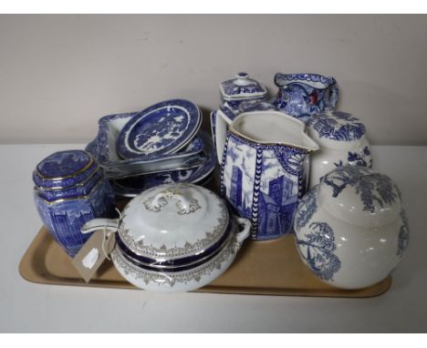 A tray containing blue and white willow pattern china, Ringtons caddies and ginger jars, three Ringtons castle tea caddies to