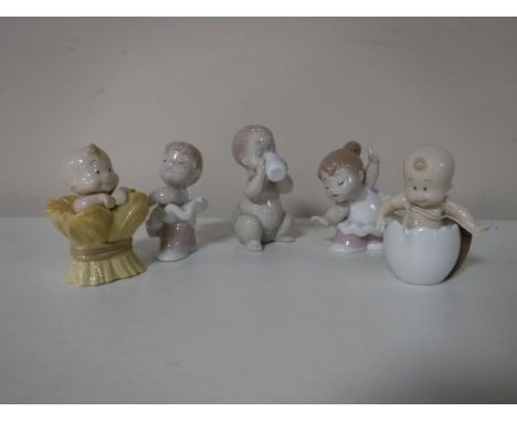 Five Nao figures, two include three babies and two ballet dancers 
