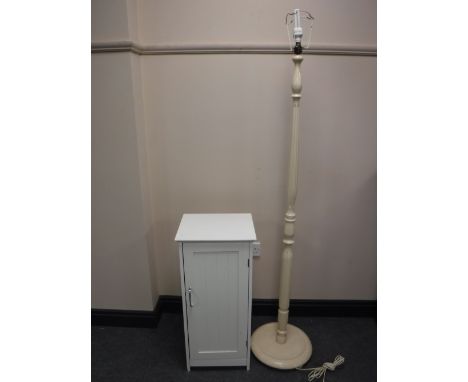 A painted standard lamp, white bathroom cabinet and a gold loom basket chair 