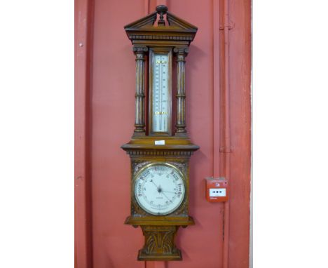 A Victorian carved oak aneroid barometer/thermometer, dial signed J. Taylor, Nottingham.