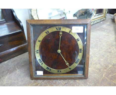 An Art Deco walnut and gilt metal strut clock