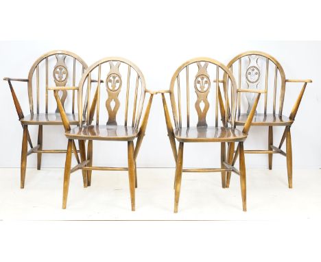 Four Ercol Fleur De Lys carver chairs with Ercol labels, H 82cm