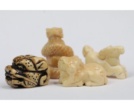 Four carved bone miniature netsuke figures to incude signed dragons head, snake coiled around gold, goat and horse