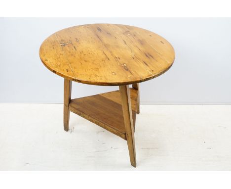 19th century and later pine cricket table, with circular top above triangular shelf on trinagular tapering legs, 70.5cm high 