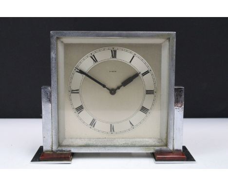 Art Deco chrome and Bakelite 8 day mantle clock, the square face held on a stepped base, 22cm wide