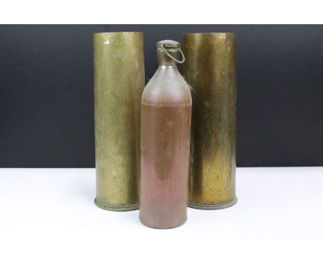 Two 1955 brass trench art shell vases, H 29cm together with a metal flask