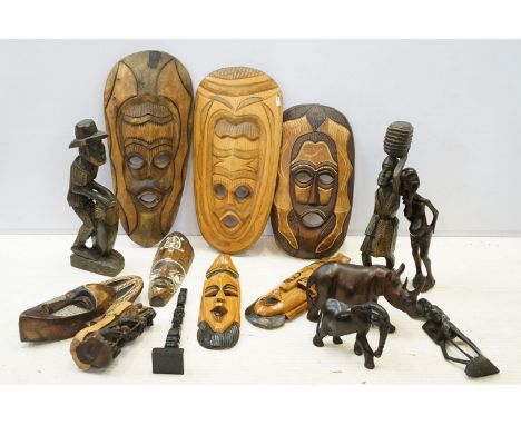 Collection of carved tribal art pieces to include masks, totems, sculptures, figurines, elephant and rhino figures