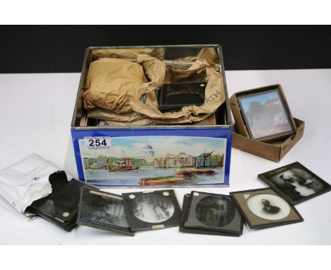 A collection of glass magic lantern slides to include Boer war sets within original boxes and real photo examples to include 