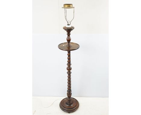 Early 20th century oak standard lamp, with circular shelf above turned twisted column and circular base, 120cm high