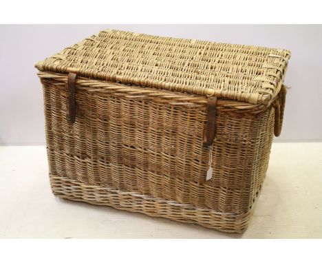 Early 20th century wicker hamper with liftable lid and strap closure, H 60cm W 85cm