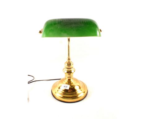A brass students lamp with green shade