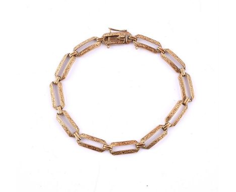 
	
		A MID 20TH CENTURY BRACELET 
		The elongated pierced gold coloured hexagonal panels with scrolled decoration, to a box c
