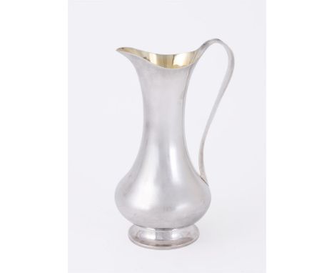 
	
		A SILVER BRITANNIA STANDARD BALUSTER ARTIST JUG
		MAKER&#39;S MARK JWG, LONDON 1988
		With a scroll handle and on a circ