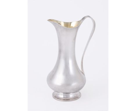 
	
		A SILVER BRITANNIA STANDARD BALUSTER ARTIST JUG
		MAKER&#39;S MARK JWG, LONDON 1988
		With a scroll handle and on a circ