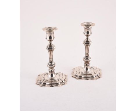 
	
		A PAIR OF VICTORIAN SILVER CANDLESTICKS
		WILLIAM HUTTON &amp; SONS LTD., LONDON 1898
		With circular sconces, reel capi