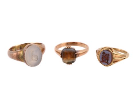 
	
		THREE HARDSTONE SIGNET RINGS
		The 19th century ring with an oval banded agate panel carved with the initials FML in got