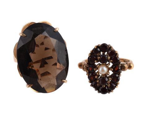 
	
		A SMOKY QUARTZ DRESS RING AND A GARNET AND CULTURED PEARL DRESS RING 
		The oval smoky quartz within a four claw 9 carat