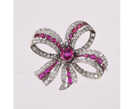 
	
		A RUBY AND DIAMOND BOW BROOCH
		CIRCA 1900 
		The circular cut ruby within a ribbon bow surround set with a graduated ce