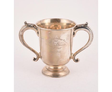 
	
		A SILVER TWIN HANDLED TROPHY CUP
		WILLIAM HUTTON &amp; SONS LTD., BIRMINGHAM 1910
		With twin leaf capped scroll handle