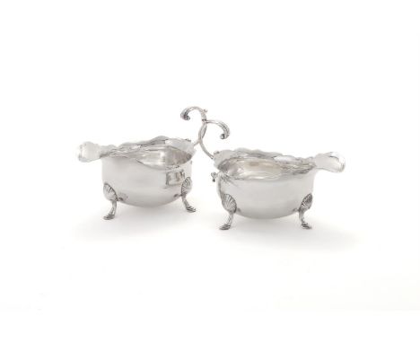 
	
		A PAIR OF GEORGE II SILVER OVAL SAUCE BOATS
		WALTER BRIND, LONDON 1748
		With shaped borders, lead capped flying scroll