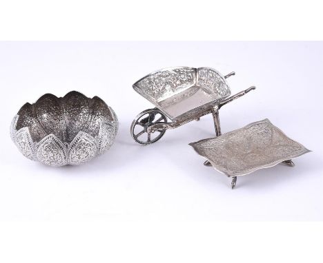 
	
		THREE INDIAN SILVER COLOURED ITEMS
		To include: a silver coloured model of a wheelbarrow by C. Krishnia Chetty, Bangalo