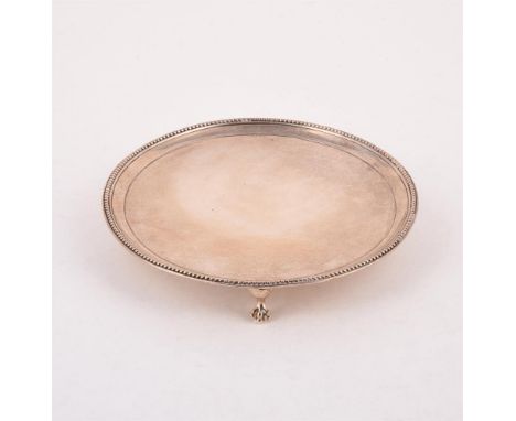 
	
		A GEORGE III SILVER CIRCULAR SALVER
		MAKER&#39;S MARK OBSCURED, LONDON 1781
		With a beaded border and on three claw an