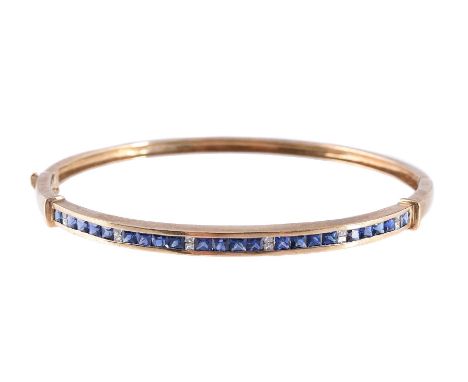 
	
		A SAPPHIRE AND DIAMOND BANGLE 
		The hinged bangle, stamped 375, channel set with square French cut sapphires between pr