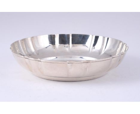 
	
		A SILVER SHAPED CIRCULAR BOWL
		THOMAS DUCROW &amp; SONS, BIRMINGHAM 1945
		With a shaped circular border
		22.5cm (9in)