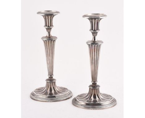 
	
		A PAIR OF SILVER CANDLESTICKS
		ELKINGTON &amp; CO. LTD., BIRMINGHAM 1935
		With reeded oval sconces, fluted capitals, f