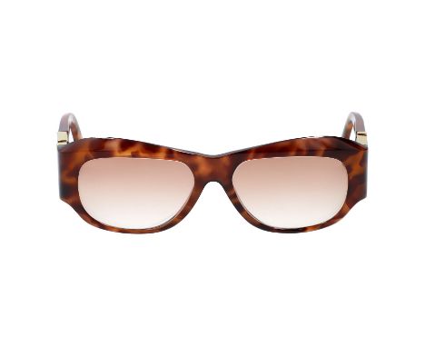GIANNI VERSACE VINTAGE Sonnenbrille "MOD T75 COL 869". Marmoriertes Gestell in Hellbraun mit leicht getönten Gläsern. Dekorat