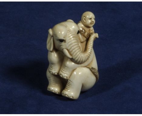 Elephant with boy netsuke, signed 