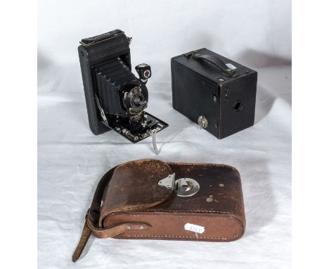 A vintage Kodak bellows camera with leather case together with a Kodak box camera