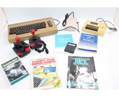 A Commodore C64 Micro Computer comprising, console, cassette player, power supply, 2x joysticks, various computer programming