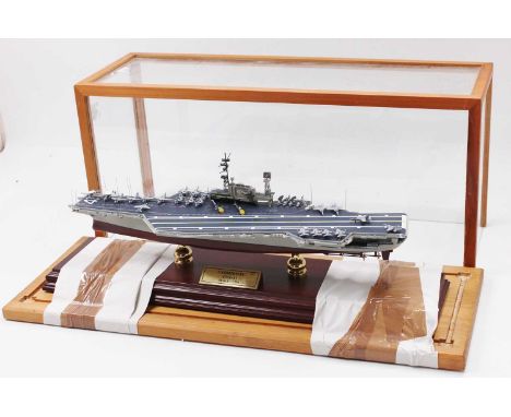 A 1:700th scale model of 'Midway' Aircraft Carrier, constructed in resin, mounted on two pillars and presented in a wood/glas