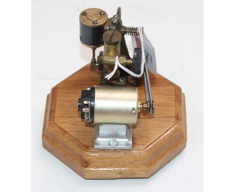 An electrically powered miniature single oscillating vertical steam engine, fitted with displacement lubricator, fully raised