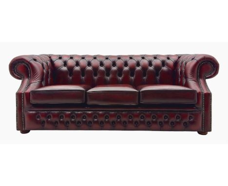Mid-to-late 20th century three-seat Chesterfield sofa, upholstered in oxblood leather, deep button tufting across the backres