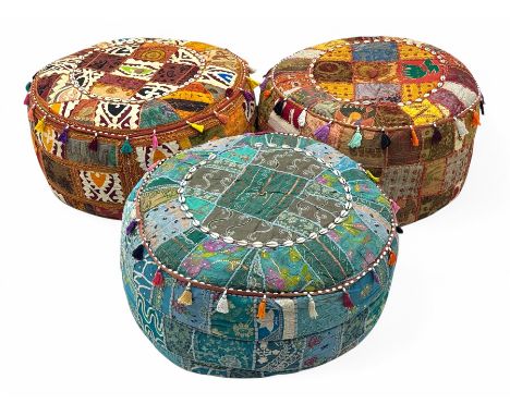Set of three vintage Indian patchwork pouffes, each featuring intricate embroidery in vibrant colours with decorative tassels