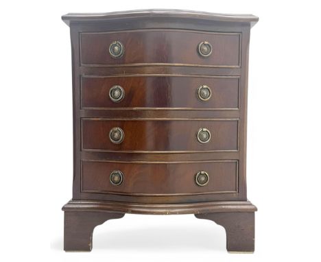 Mid-20th century serpentine-front miniature mahogany chest, fitted with four cock-beaded drawers, brass ring handles with ros