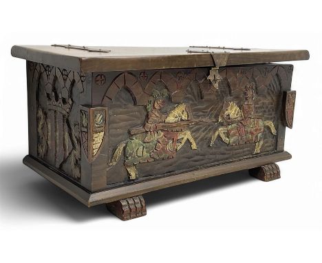 Mid-20th century carved hardwood chest, the rectangular hinged top with decorative strap hinges, the front and sides deeply c