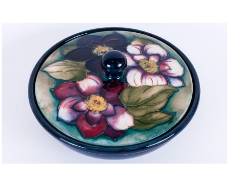 Moorcroft 'Clematis' Pattern Powder Bowl, the cover decorated with three clematis flowers of pink, mixed darker pink and purp