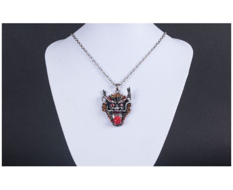 Oriental Dragon Head Pendant, the blackened face framed with golden orange crystal 'dragon's scales', the eyes and horns stud