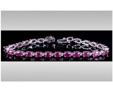 Ruby Tennis Bracelet, 18cts of rubies with a deep fuchsia pink undertone, oval cut and set in silver in a tennis bracelet des