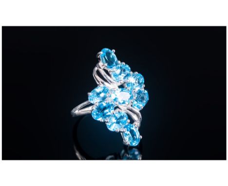 Swiss Blue Topaz Lozenge Cluster Ring, a total of eight oval cut Swiss blue topaz, set in a lozenge shape divided by a curved