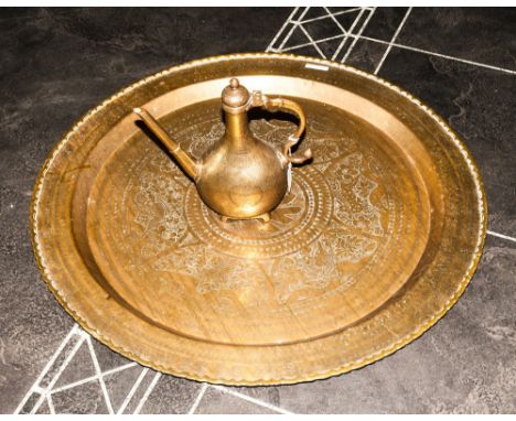 A Large Chinese Brass Table Top with engraved Chinese characters to the centre with a floral decorated edge, 36 inches diamet