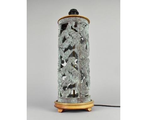 A Heavy Oriental Cast Metal Green Patinated Cylindrical Table Lamp Decorated with Dragons, 53cms High, No shade. 